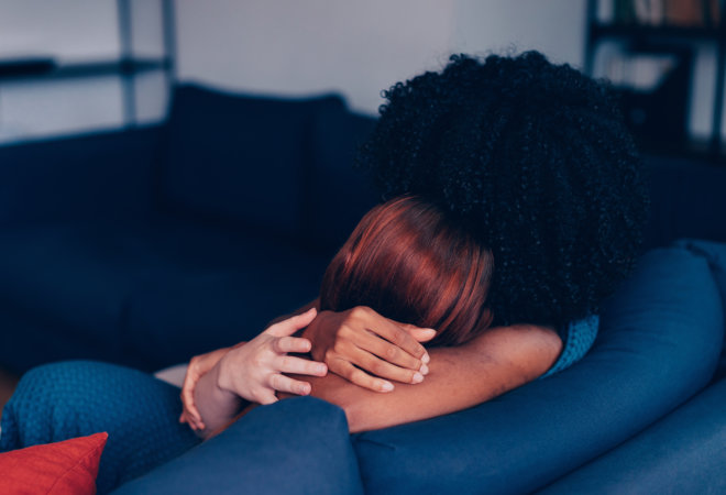 Two person hugs each other