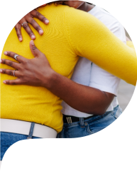 woman hugging friend in city street.