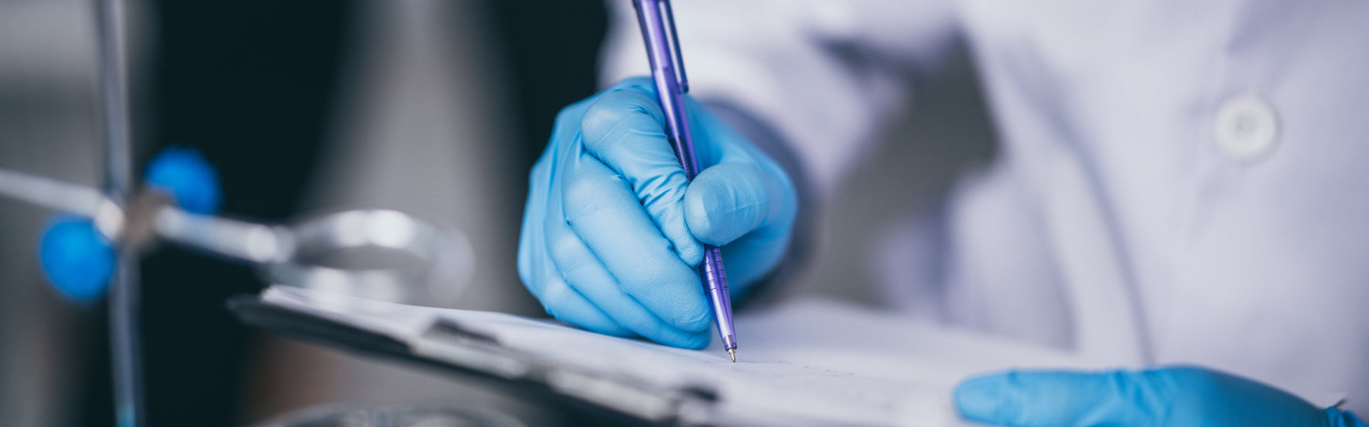 a close-up view of a person writing on a clipboard