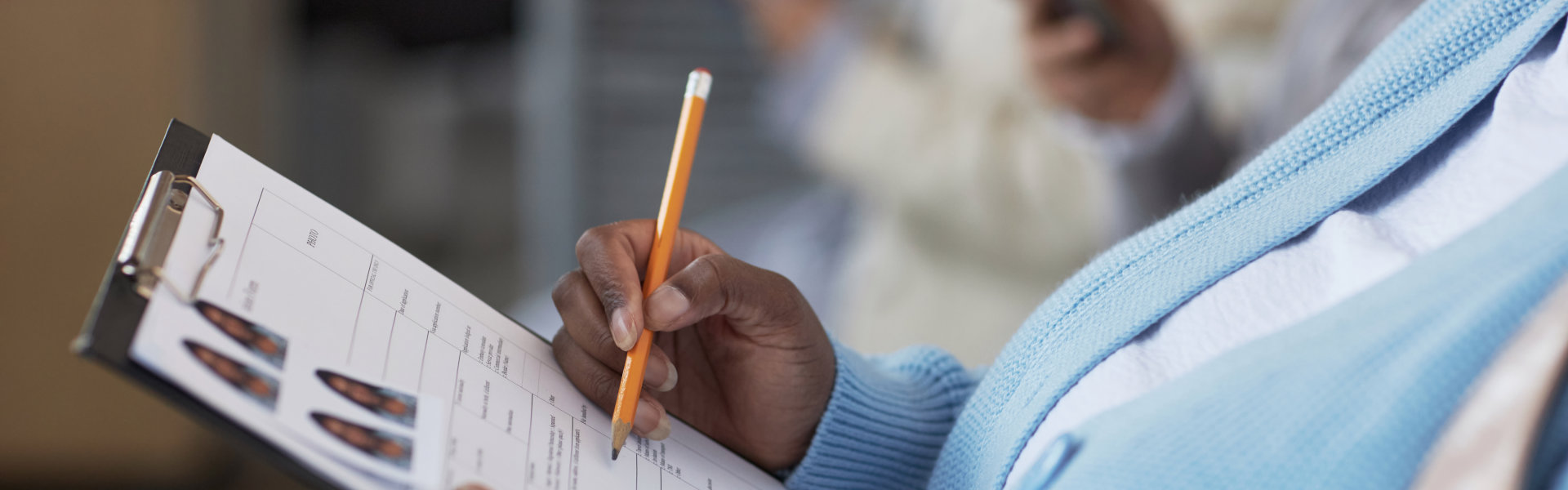 female applicant with pencil pointing at filled form